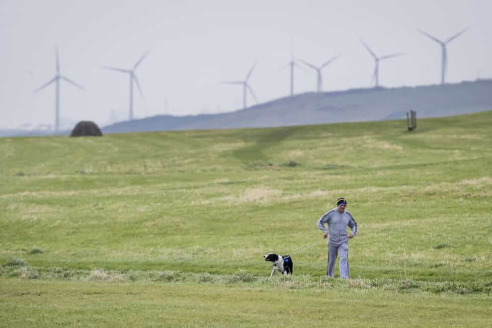 A man walking his dog near Whitehaven in Cumbria