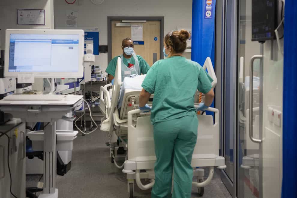 Staff nurses transfer a patient through the Emergency Department at St George’s Hospital in Tooting, south-west London