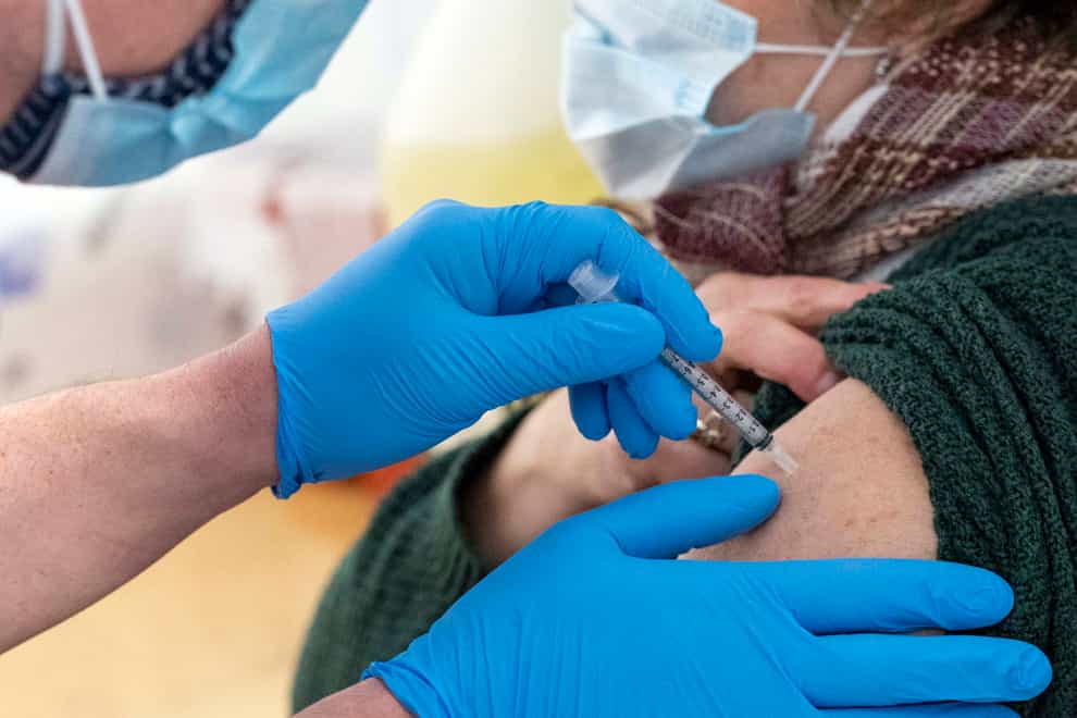 a nurse administers the first dose of the coronavirus vaccine at a pop-up COVID-19 vaccination site