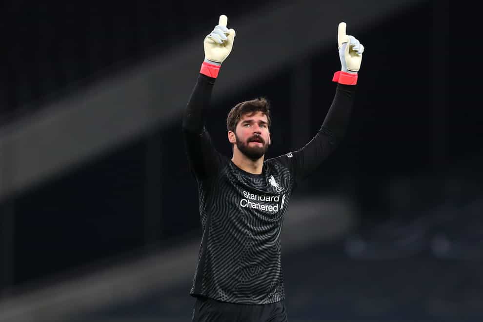 Liverpool goalkeeper Alisson Becker points to the sky