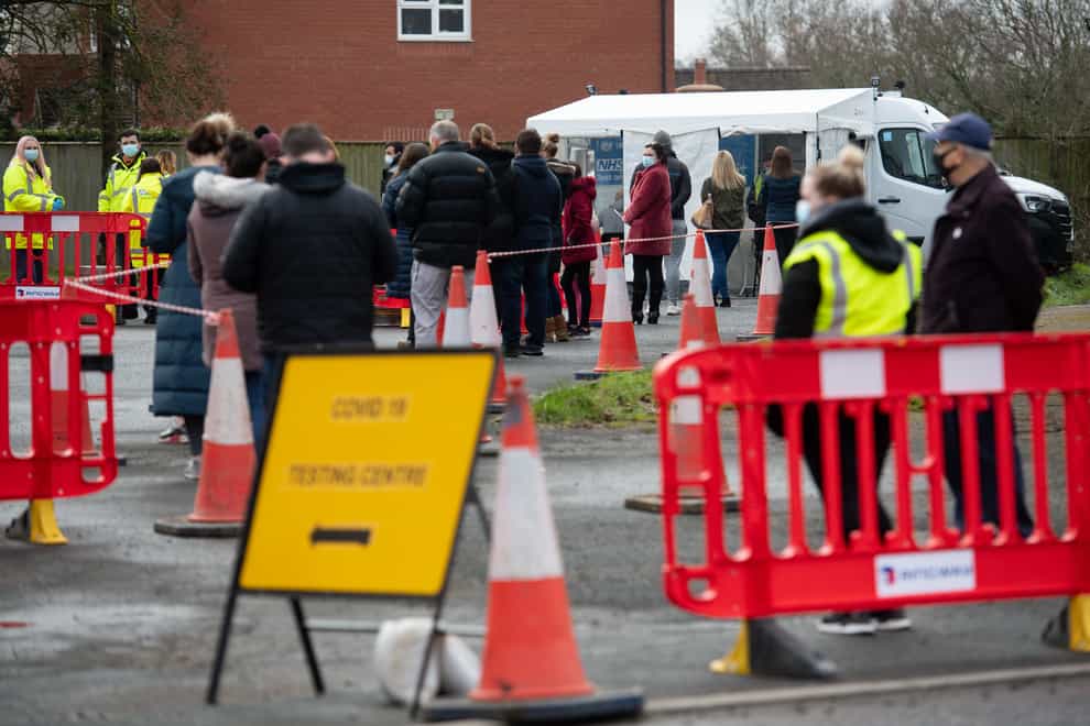 People wait to be tested at a Covid-19 mobile testing unit set up at the White Hart pub in Fernhill Heath, near Worcester
