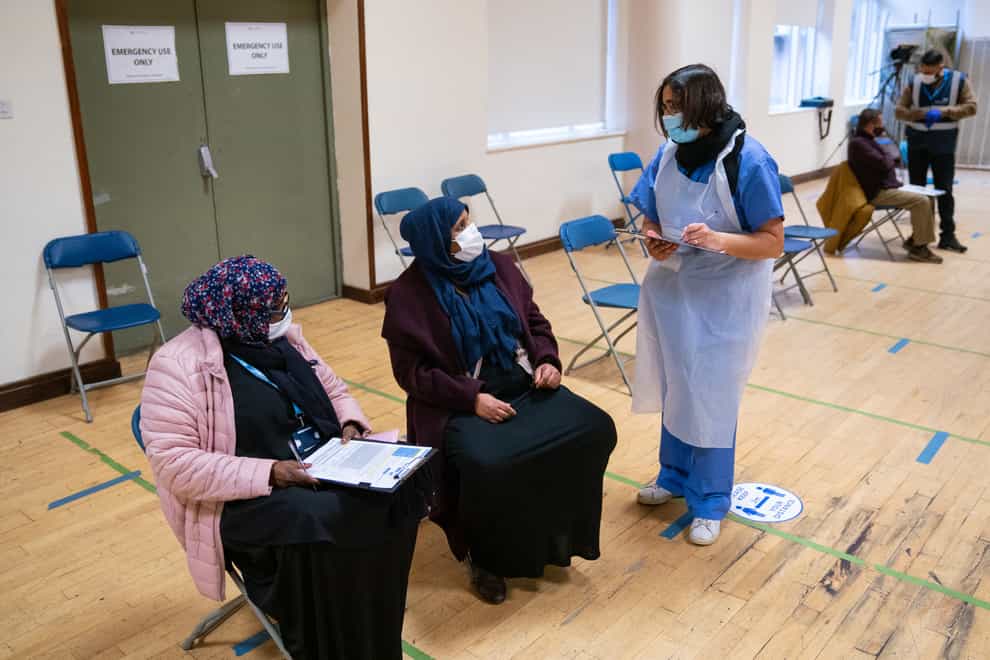 People attend a pop-up Covid-19 vaccination centre at the East London Mosque in Whitechapel