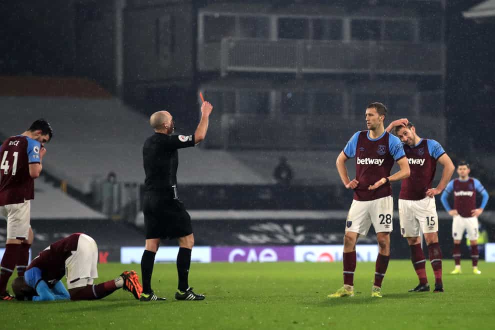 Referee Mike Dean shows West Ham’s Tomas Soucek a red card