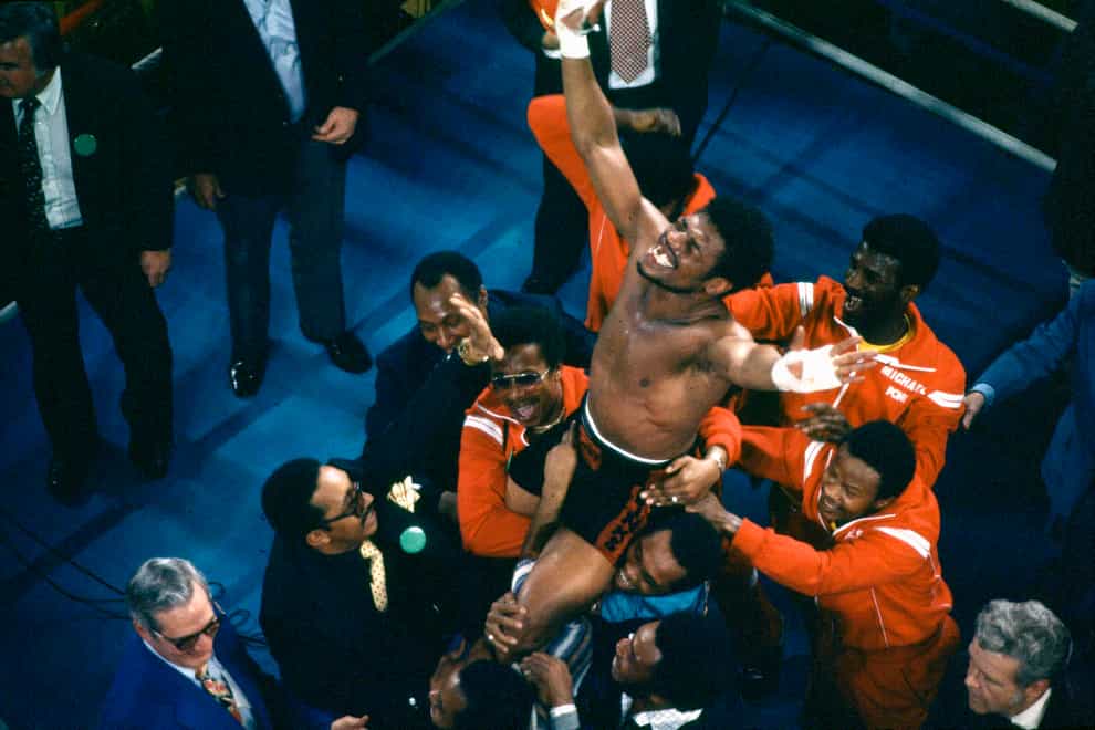 Leon Spinks celebrates as his entourage holds him aloft after his defeat of Muhammad Ali in 1978