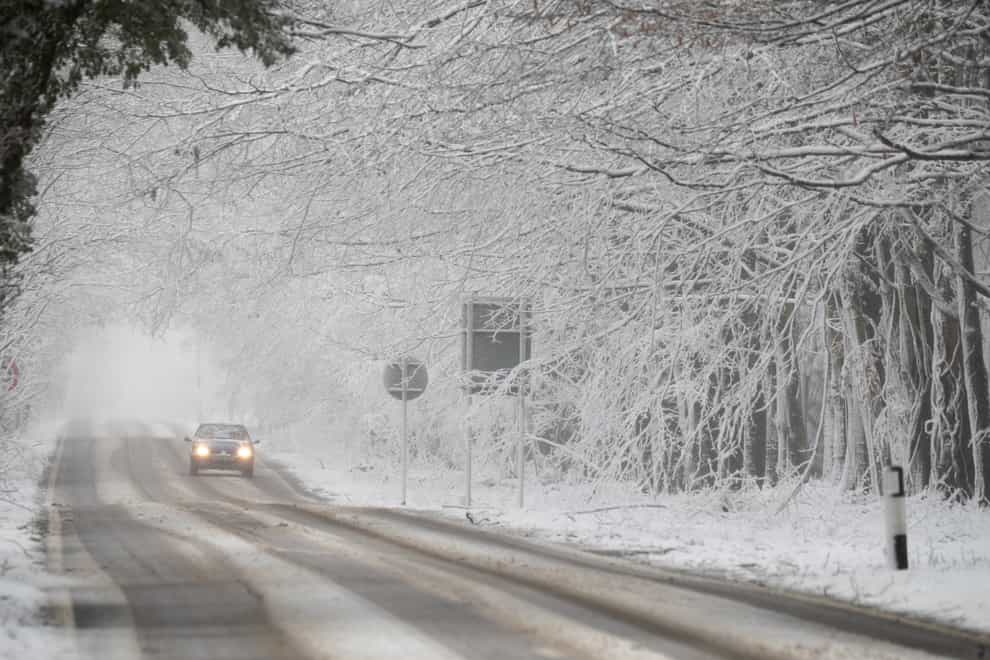 A car makes its way along a snow-covered road in Kent