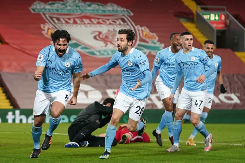 Ilkay Gundogan (left) opened the scoring after missing an earlier penalty as Manchester City won at Liverpool.
