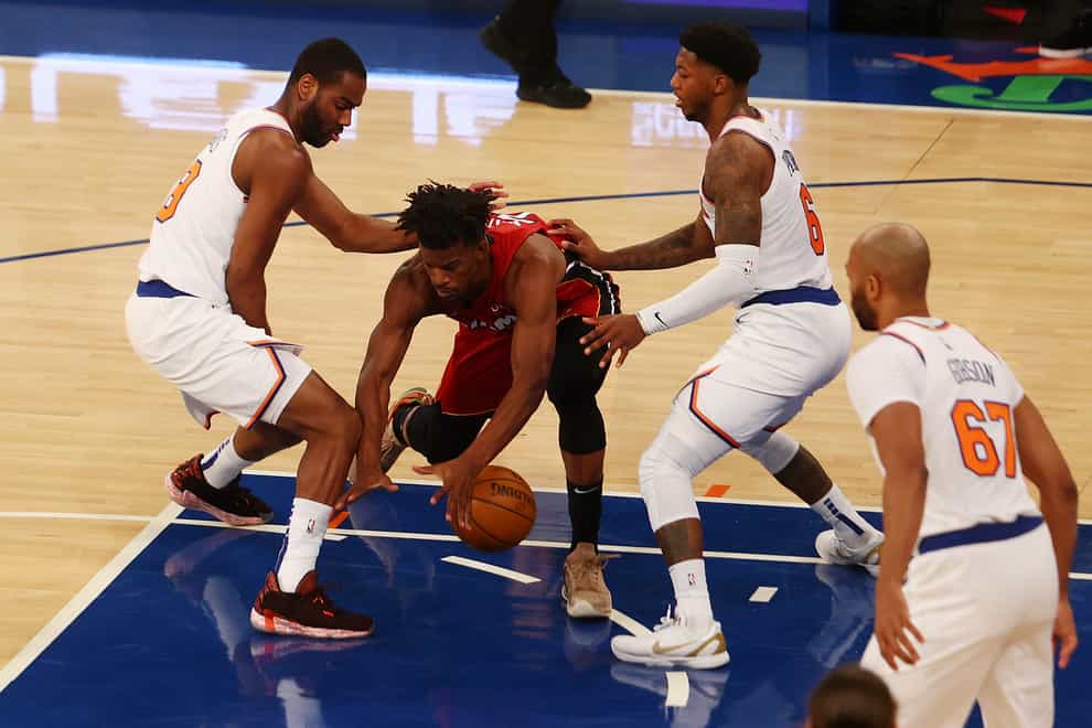 Alec Burks, left and Elfrid Payton, right, of the New York Knicks defends against Jimmy Butler