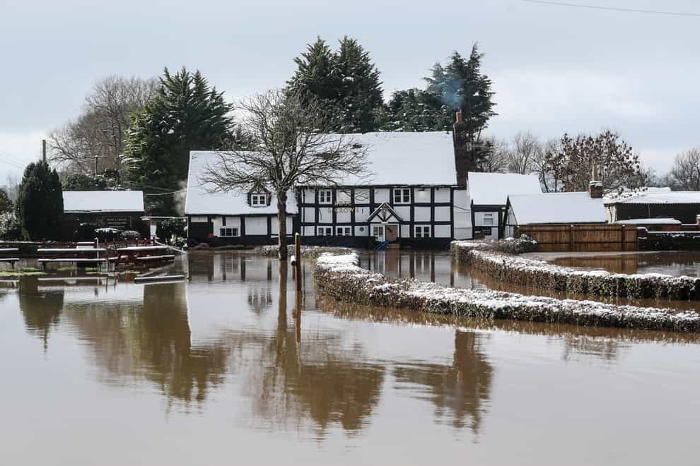 The Rose and Crown pub in Severn Stoke is cut off by floods (David Davies/PA)
