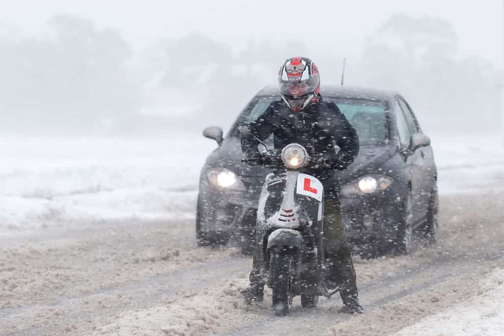 Vehicles make their way through snow and blizzard conditions near Kirby Cross in Essex
