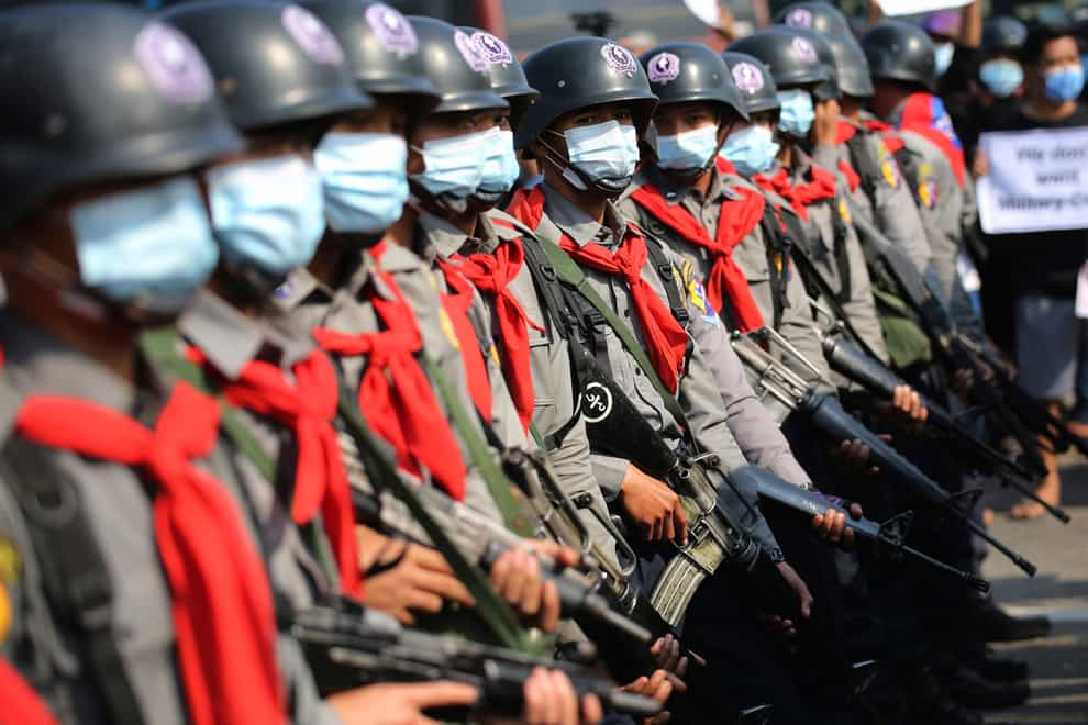 Armed riot police are seen near protesters in Naypyitaw, Myanmar