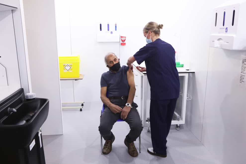 Olivia Smart, advanced practitioner and Leeds Ladies FC defender, vaccinates Mewa Singh Khela, 72, with his first dose of the Oxford/AstraZeneca coronavirus vaccine at the Elland Road vaccination centre in Leeds