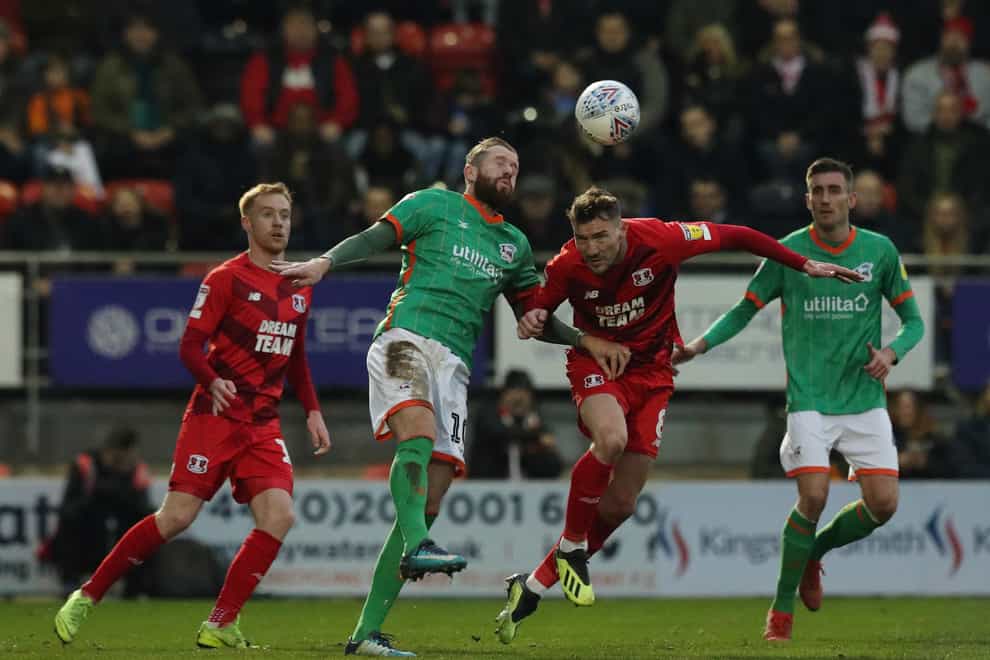Scunthorpe forward Kevin Van Veen (centre left) heads the ball away