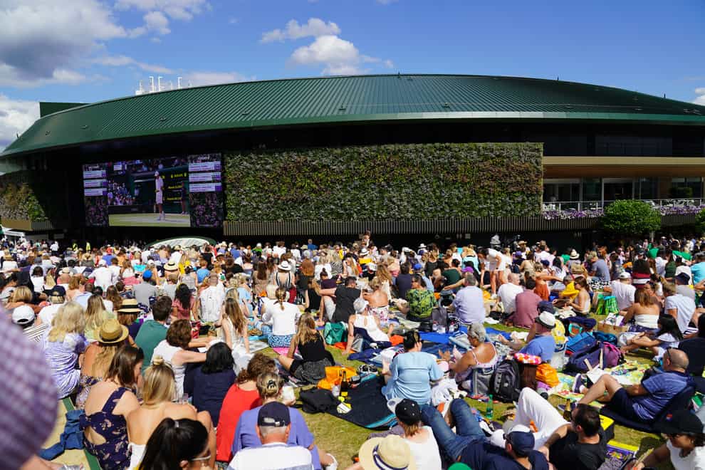 A general view of spectators watching centre court action from Murray Mound at Wimbledon