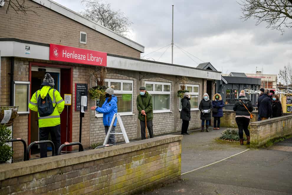 People wait in line for a coronavirus test at a surge test centre