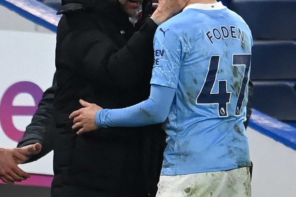 Pep Guardiola (left) and Phil Foden on the touchline