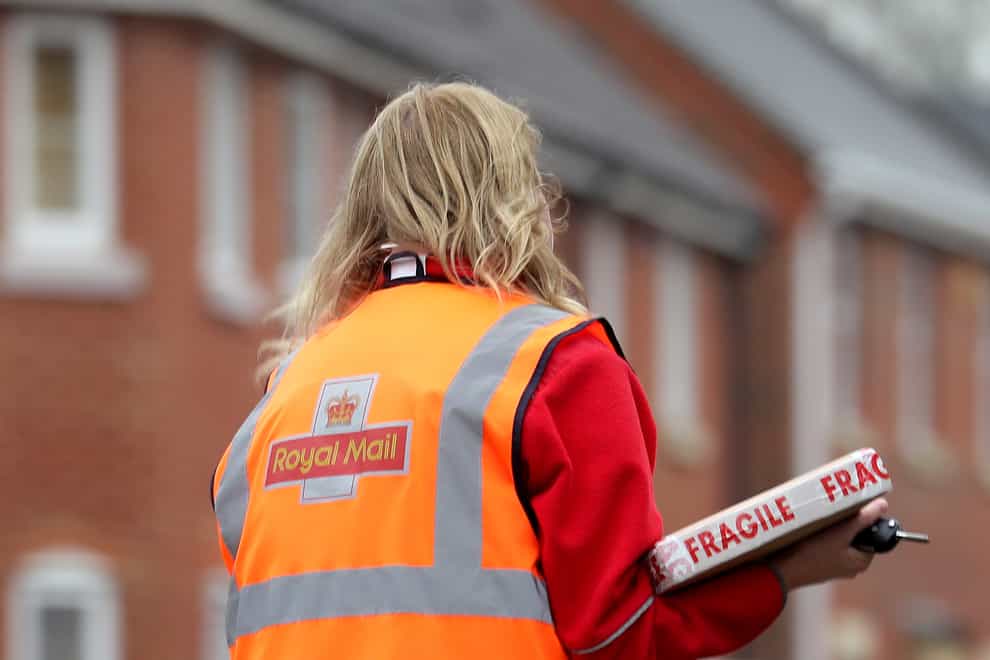 A royal mail worker delivering a package