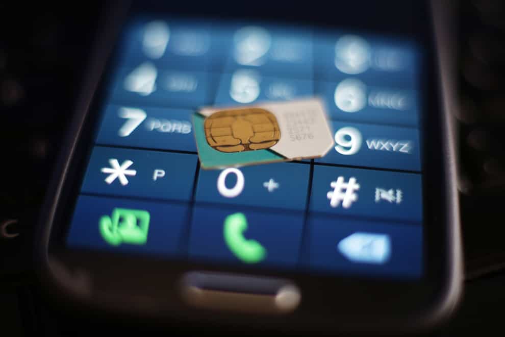 A sim card on the keypad of a mobile phone