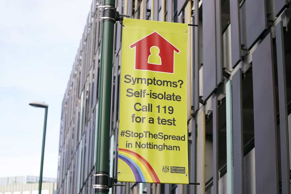 A sign telling people to self-isolate if they have Covid-19 symptoms