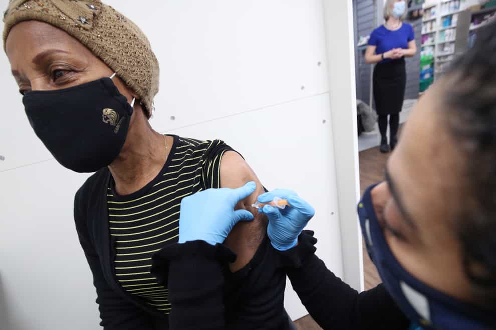 Asha Fowells gives Judy Phillips a coronavirus vaccination