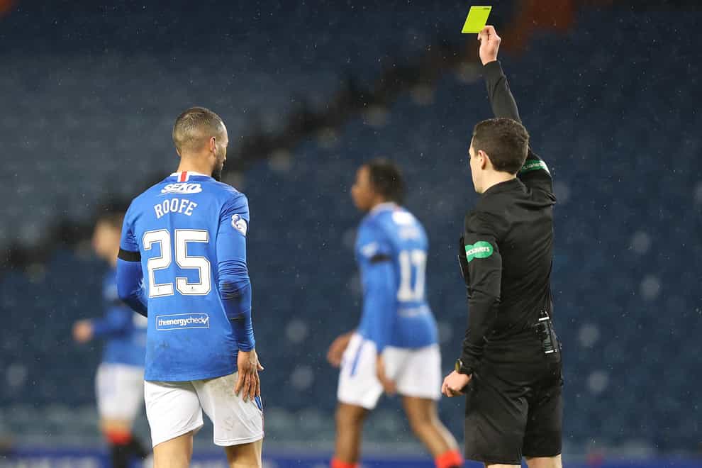 Referee David Munro (right) shows a yellow card to Rangers’ Kemar Roofe for a late challenge during their Scottish Premiership clash