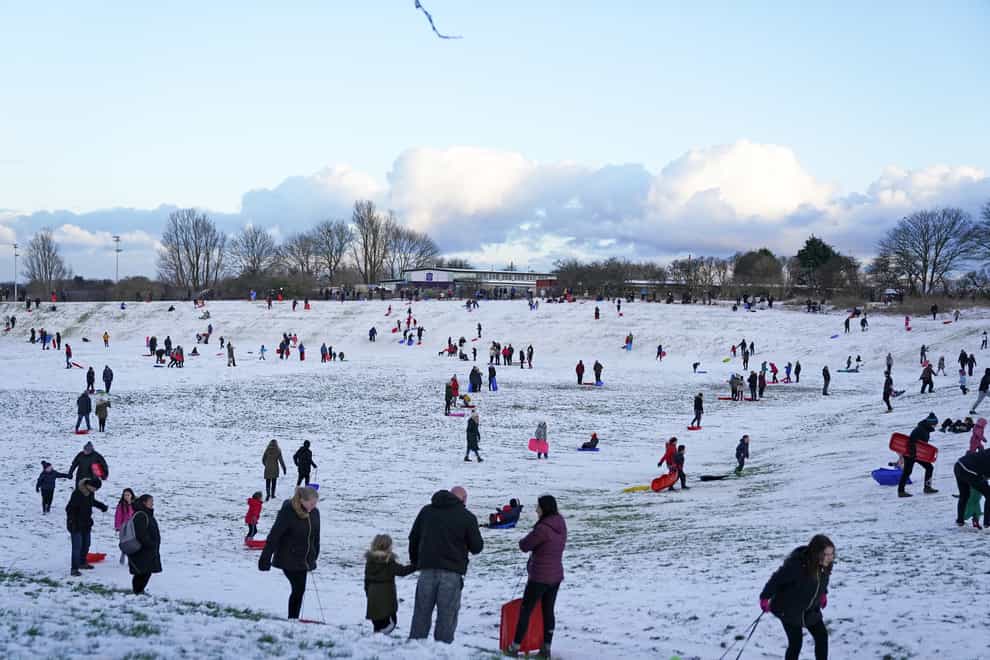 People sledging in a snow covered park in Whitley Bay
