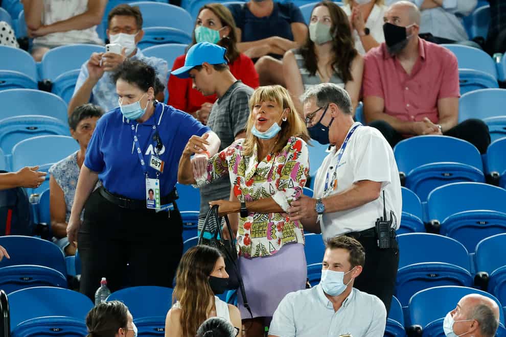 A spectator is escorted from the Rod Laver Arena