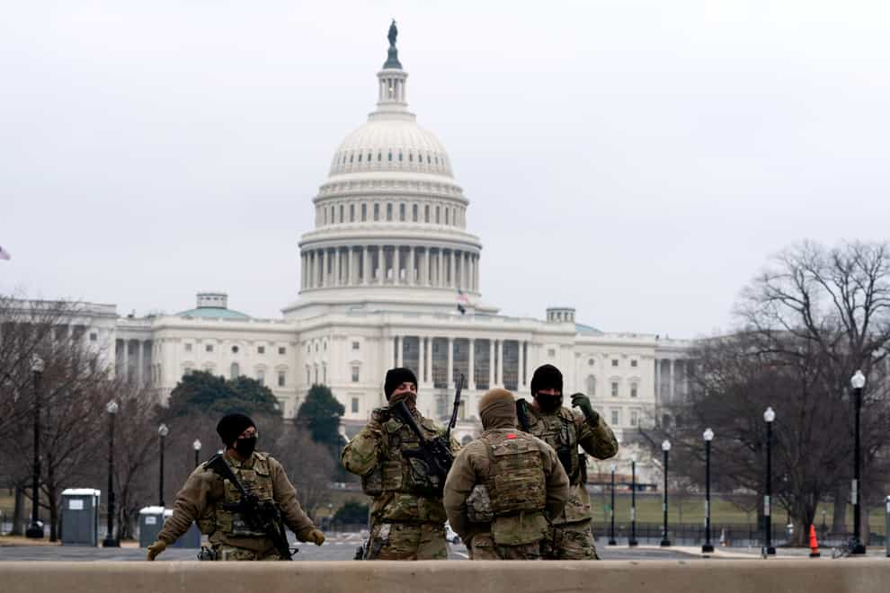 Members of the National Guard patrol the area outside of the US Capitol