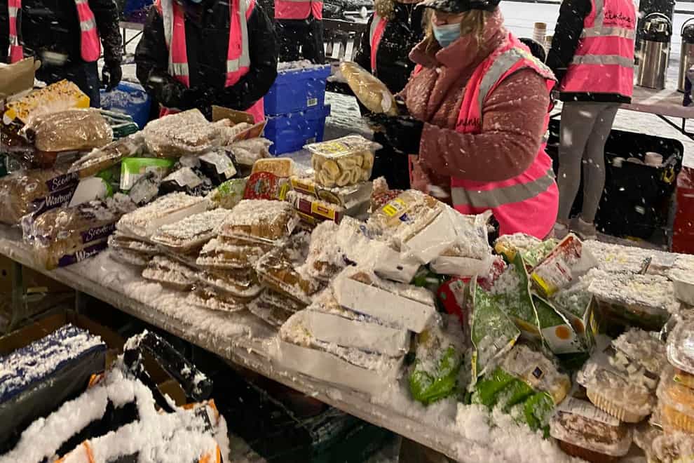 Charity workers help the homeless on a snowy night in Glasgow