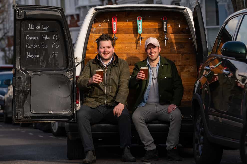 George Dean (left, a former bar manager and Finn Bruce, a video director with their Pub-on-wheels in Clapham, south London (Aaron Chown/PA)