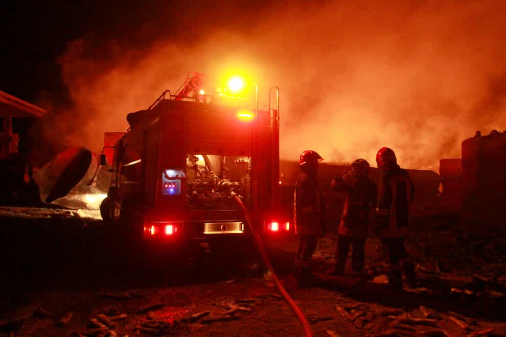 Firefighters work on a burning tanker carrying fuel