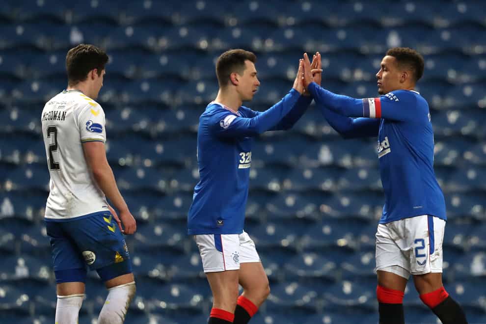 Rangers’ Ryan Jack (centre) greets James Tavernier (right) after the final whistle at Ibrox on Saturday (Andrew Milligan/PA)