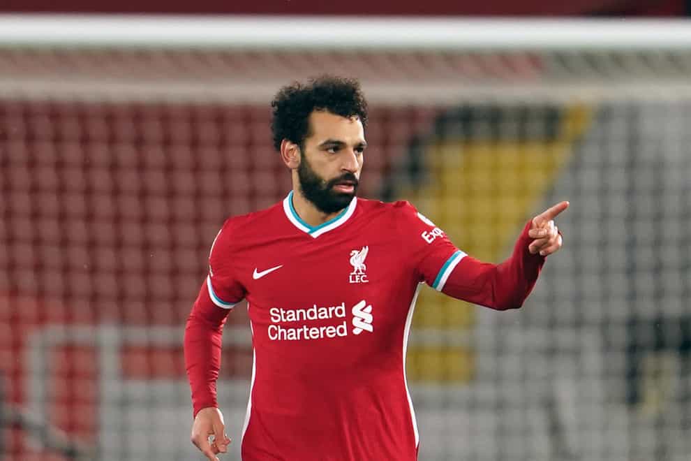 Liverpool forward Mohamed Salah points as he runs