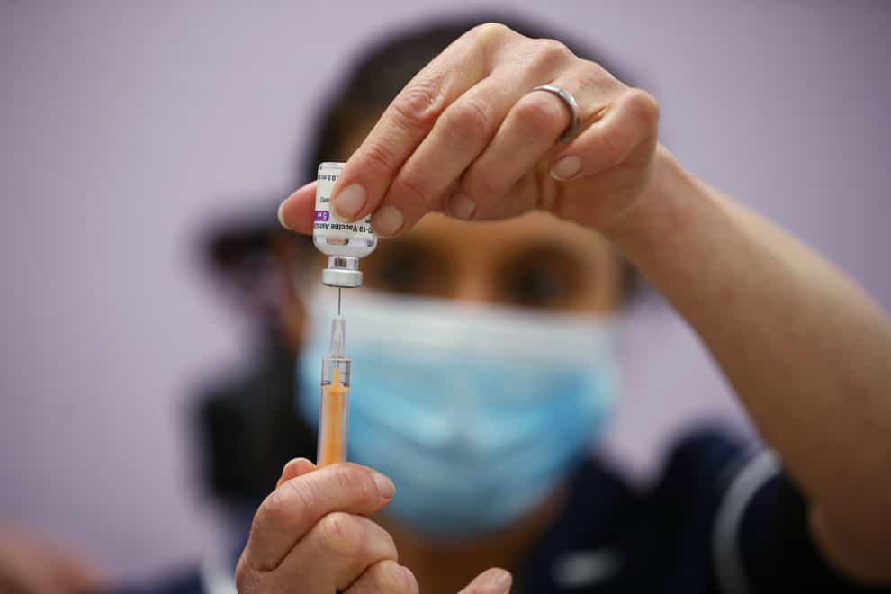 A senior immunisation nurse prepares a dose of Oxford/Astra Zeneca Covid-19 vaccine