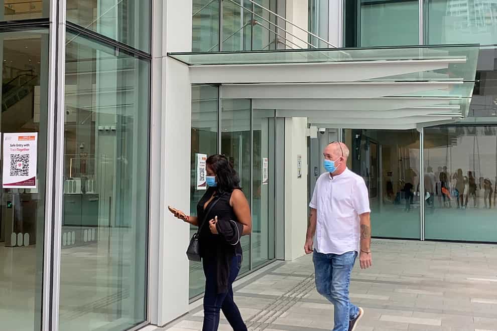 Agatha Maghesh Eyamalai, left, and Skea Nigel walk into the State Courts in Singapore