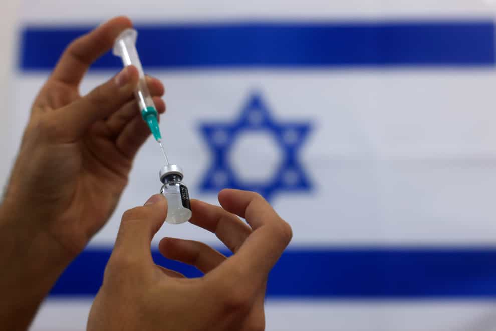 An Israeli military paramedic prepares a Pfizer Covid-19 vaccine