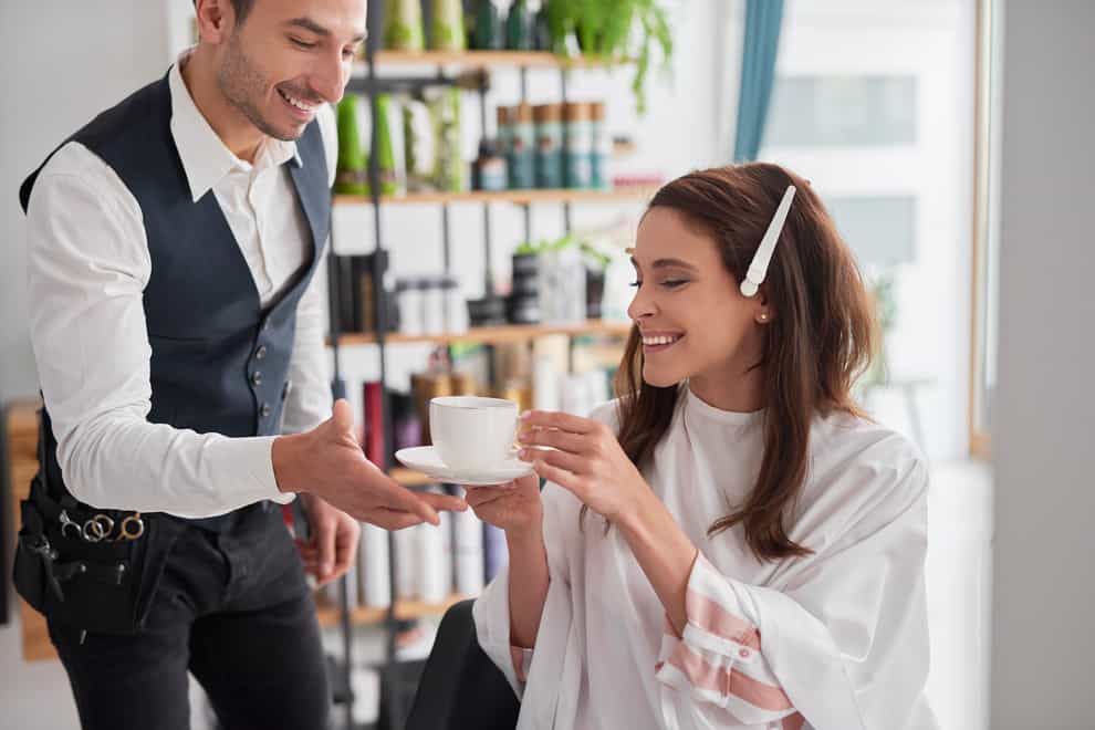 woman drinking coffee in hair salon
