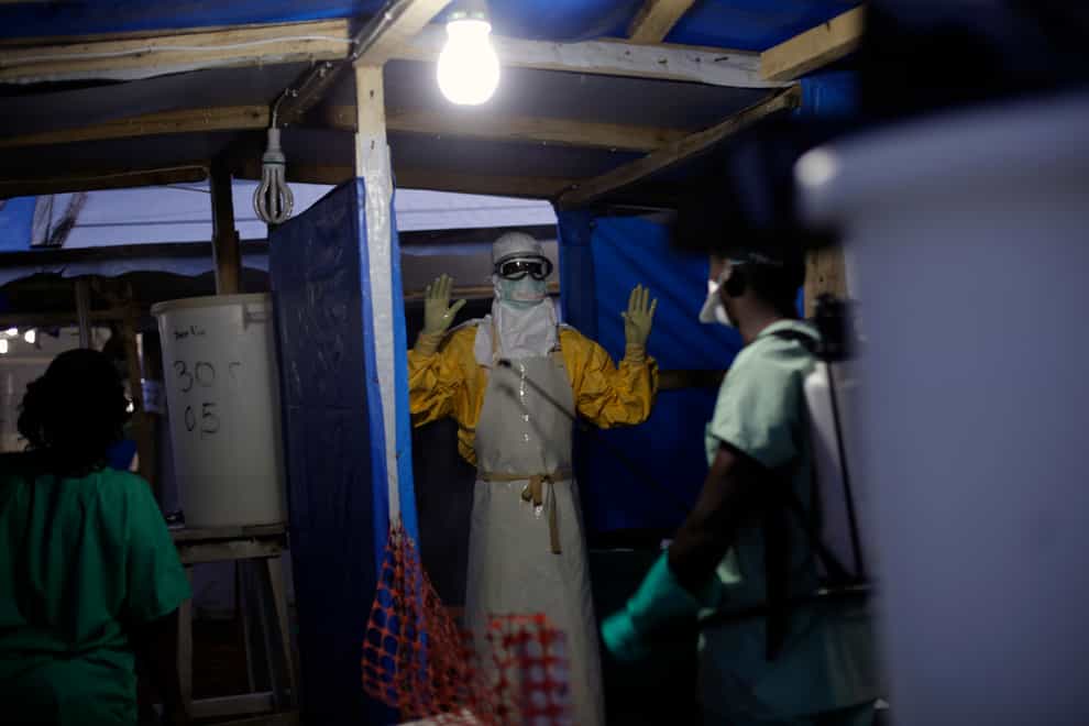 A health worker is sprayed as he leaves the contaminated zone at the Ebola treatment centre in Gueckedou, Guinea