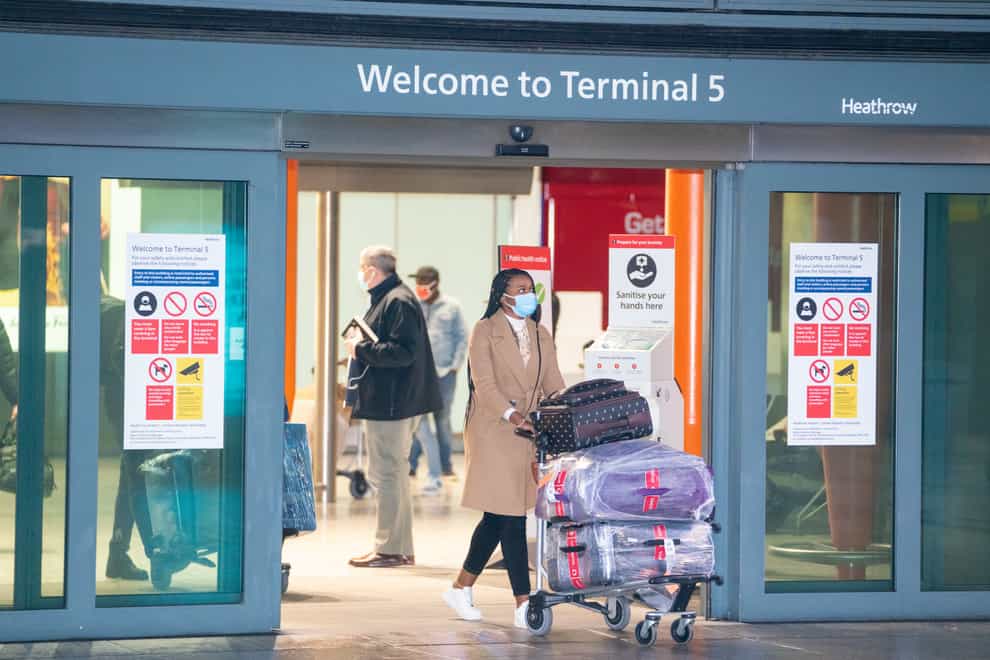 Passengers arrive at London Heathrow’s Terminal 5 on the first flight to the airport from one of 33 “red list” countries to which new mandatory coronavirus rules apply, before heading to a 10 day quarantine in a Government-designated hotel
