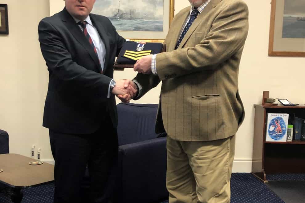 Handout photo issued by Liberty of Falklands veteran Joe Ousalice (right) being given his medal for long service and good conduct by Defence Secretary Ben Wallace