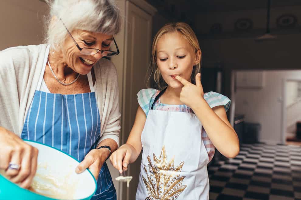 A grandmother and grandaughter cooking together (iStock/PA)