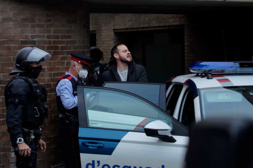 Rap singer Pablo Hasel is detained by police officers (Joan Mateu/AP)