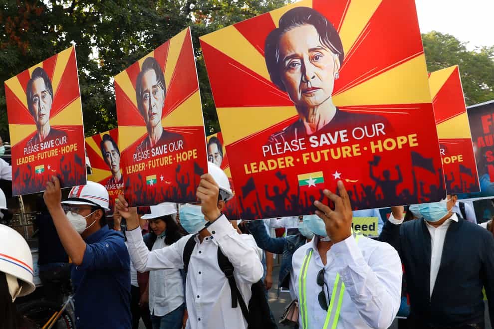 Engineers hold posters with an image of deposed Myanmar leader Aung San Suu Kyi as they hold an anti-coup protest march in Mandalay, Myanmar