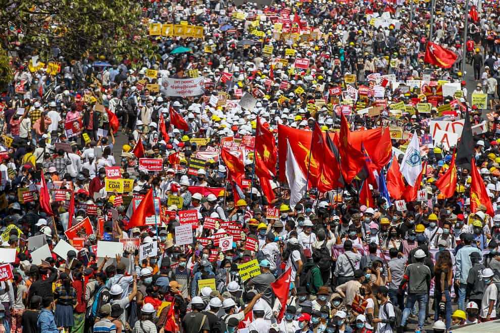 Demonstrators gather in an intersection close to Sule Pagoda to protest against the military coup in Yangon, Myanmar (AP)