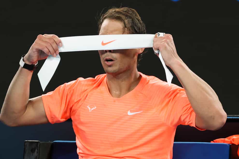Rafael Nadal adjusts his headband