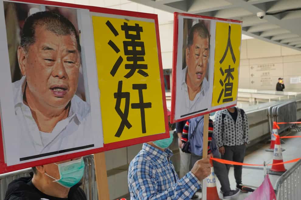 Pro-China supporters hold the pictures of prominent Hong Kong democracy advocate and newspaper founder Jimmy Lai with Chinese words “Traitor of China”