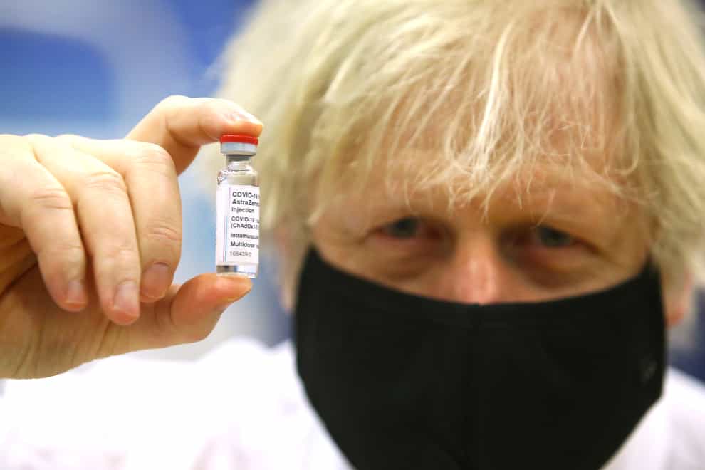 Prime Minister Boris Johnson holding a vial of the Oxford/Astra Zeneca Covid-19 vaccine as he visits a vaccination centre at Cwmbran Stadium in Cwmbran, south Wales (Geoff Caddick/PA)
