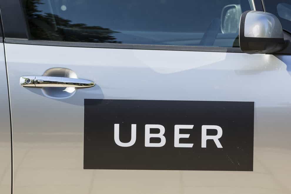 The logo of Uber on a car door. Supreme Court justices are set to decide whether Uber drivers should be classed as workers (Laura Dale/PA)