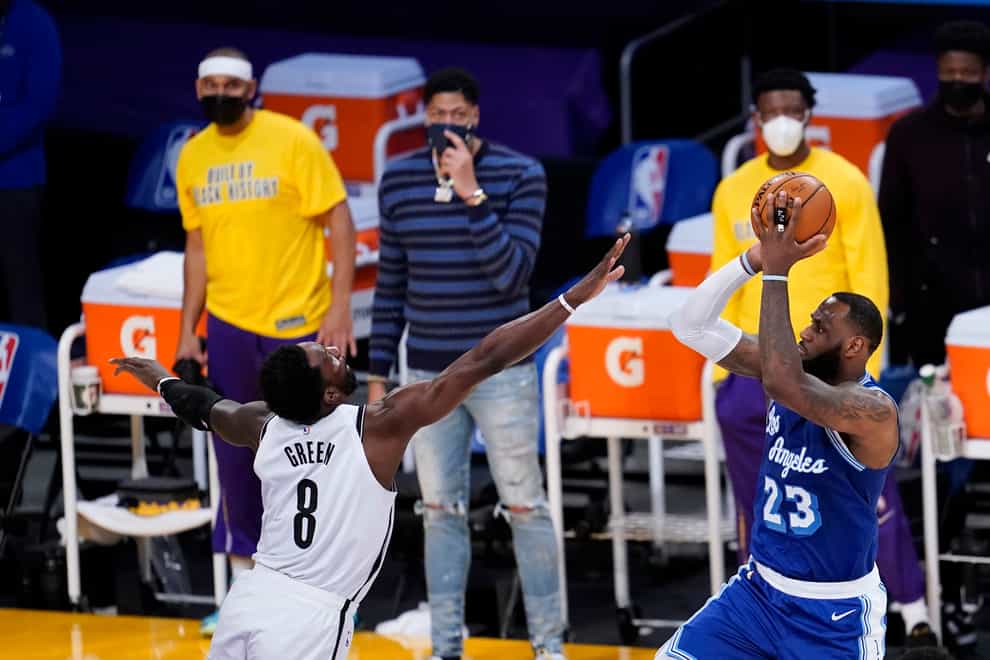 Los Angeles Lakers forward LeBron James, right, shoots over Jeff Green