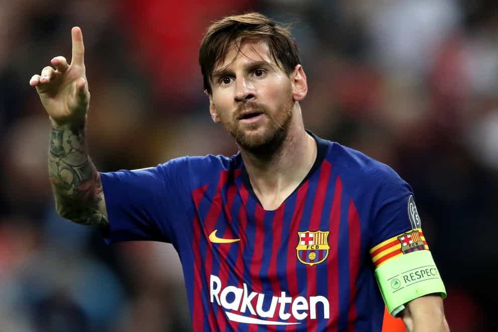 Barcelona forward Lionel Messi raises his hand