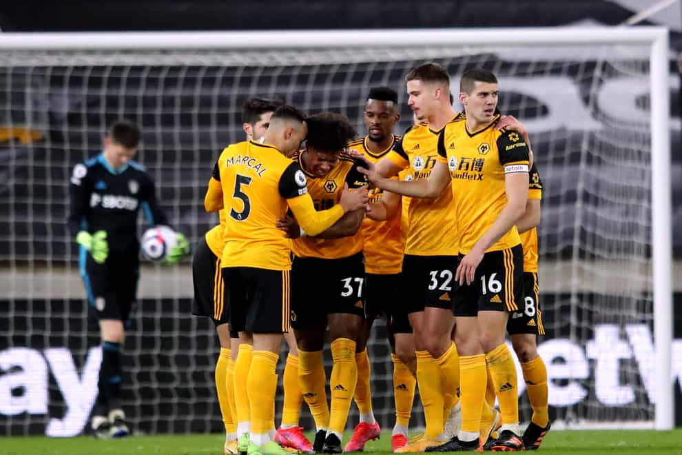 Wolves players celebrate after Illan Meslier's own goal